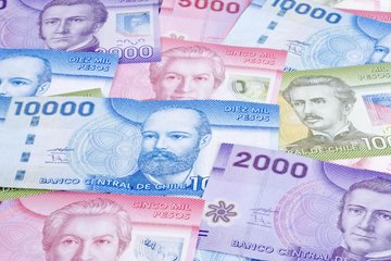 A collection of Chilean currency featuring 2000, 5000, and 10000 peso banknotes, showcasing intricate designs and vibrant colors from Banco Central de Chile.